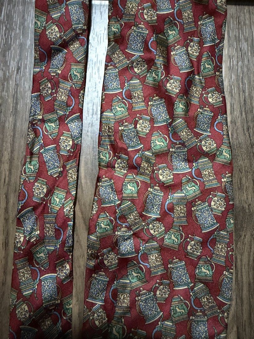 Pierre Balmain Paris Silk Necktie Beer Stein Print (Category: Ties) located in Digos. Submitted by old_soul. (Listing ID 1470694967, Image 2). Description: - Brand: Pierre Balmain Paris (Made in France) - Material: Premium silk with a smooth finish - Color & Design: Rich red with an all-over traditional beer steins and mugs print - Size: Standard width - Style: Great for adding character to formal wear or business casual outfits.