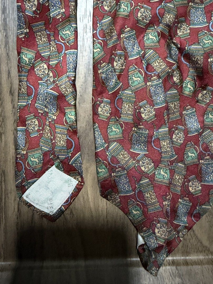 Pierre Balmain Paris Silk Necktie Beer Stein Print (Category: Ties) located in Digos. Submitted by old_soul. (Listing ID 1470694967, Image 3). Description: - Brand: Pierre Balmain Paris (Made in France) - Material: Premium silk with a smooth finish - Color & Design: Rich red with an all-over traditional beer steins and mugs print - Size: Standard width - Style: Great for adding character to formal wear or business casual outfits.
