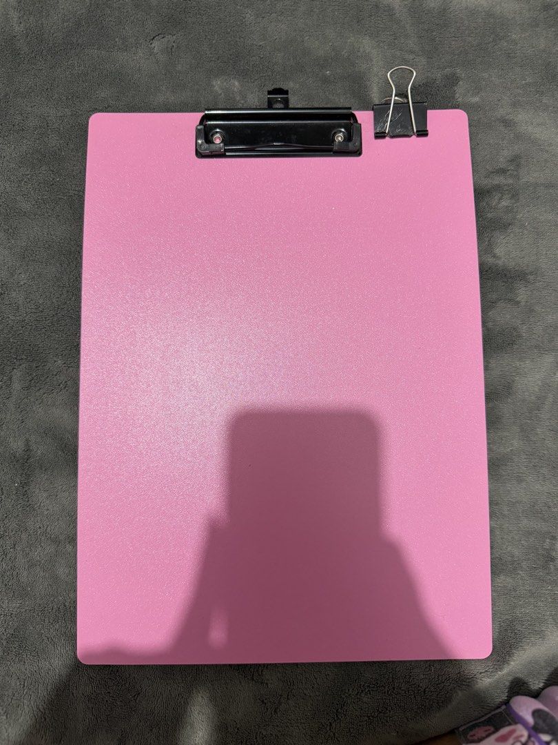 Pink A4 Plastic Clipboard with clip (Category: Stationery & School Supplies) located in Mandaluyong City. Submitted by josa_xox0i8 (Listing ID 1470665650, Image 1). Description: Item: Pink A4-size clipboard with a sturdy metal clip. Condition: Pre-owned, well-maintained, and clean. Perfect for school, office use, nursing notes, or organizing documents. Inclusions: Includes a binder clip as shown in the photos. Reason for selling: Decluttering..
