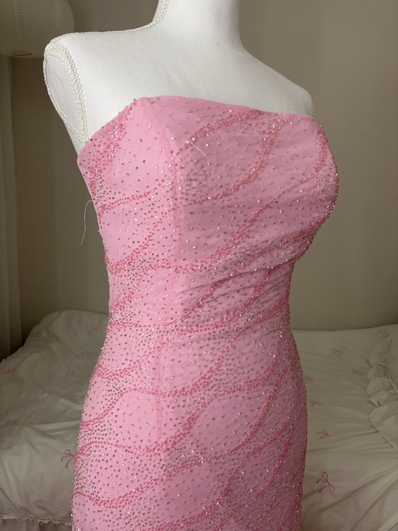 Pink Beaded Strapless Formal Gown with Train (Category: Evening dresses & gowns) located in Binan City. Submitted by andreagailaputen (Listing ID 1470620923, Image 2). Description: - Style: Strapless formal evening dress with a fitted silhouette and small train - Design: Fully covered in pink and silver sequins and beads in an eye-catching wavy pattern - Back Details: Secure back zipper closure with hook-and-eye, plus a stunning adjustable lace-u