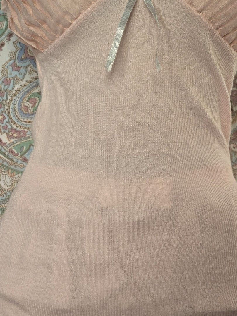Pink camisole with lace trim (Category: Sleeveless) located in Dagupan City. Submitted by chislocker14 (Listing ID 1470598043, Image 3). Description: - Color: Soft pink - Material: Stretchy ribbed knit fabric - Design: Spaghetti straps, pleated bust with lace trim and white ribbon bow - Feature: Attached layered pink ruffled skirt at the hem - Style: Coquette / Y2K / Casual cute.