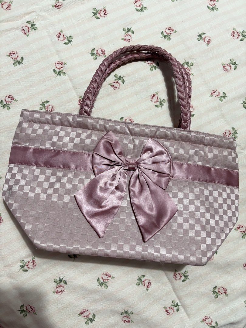 Pink naraya bag with ribbon (Category: Tote Bags) located in Sual. Submitted by cinnamorol_lovar (Listing ID 1470621426, Image 1). Description: - Color & Pattern: Dusty pink with a cute checkered fabric design - Accents: Matching satin ribbon stripe and a large satin bow on the front - Handles: Comfortable braided twin handles for easy carrying - Design: Open top with a soft, medium-sized structure.