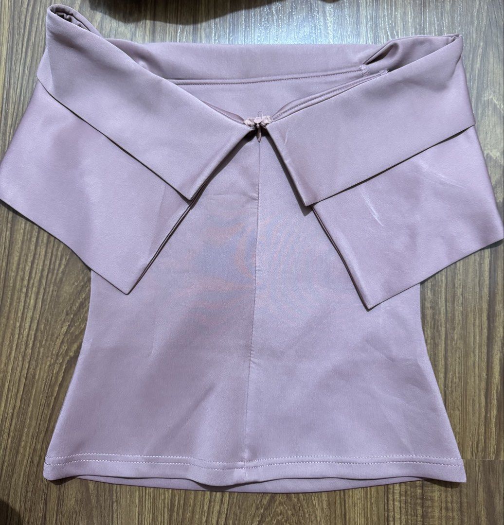 Pink off-shoulder layered top (Category: Sleeveless) located in Manila. Submitted by m.pat (Listing ID 1470681316, Image 3). Description: - Color: Dusty pink - Style: Off-shoulder with a layered foldover neckline - Fit: Fitted body style - Fabric: Smooth with a slight sheen - Versatile piece, perfect to pair with jeans or skirts for a night out.