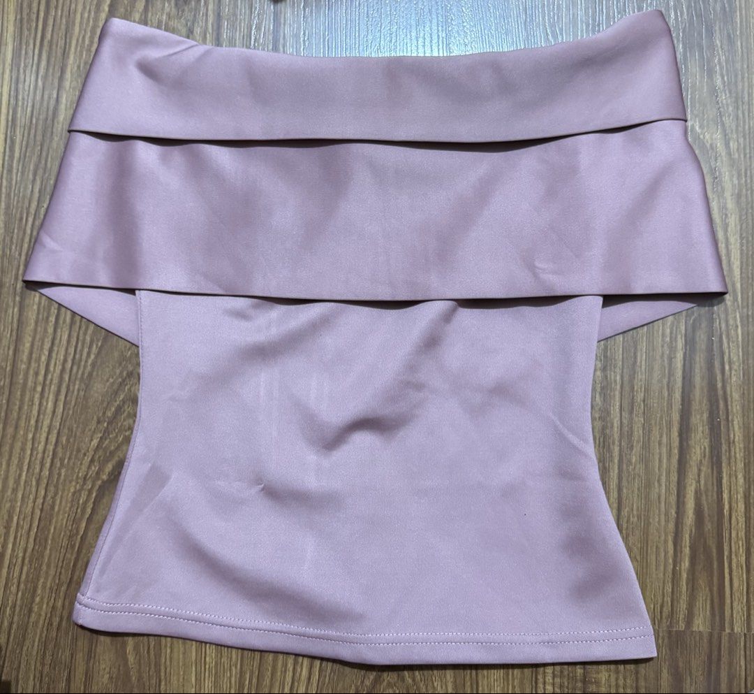 Pink off-shoulder layered top (Category: Sleeveless) located in Manila. Submitted by m.pat (Listing ID 1470681316, Image 1). Description: - Color: Dusty pink - Style: Off-shoulder with a layered foldover neckline - Fit: Fitted body style - Fabric: Smooth with a slight sheen - Versatile piece, perfect to pair with jeans or skirts for a night out.