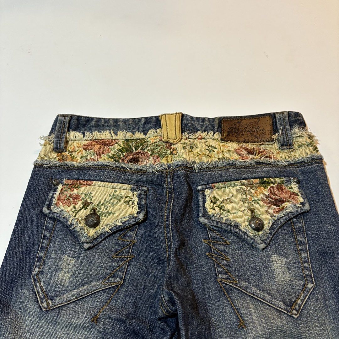 Pink Papillon Floral Patchwork Flare Denim Jeans (Category: Jeans) located in Dipolog. Submitted by dionato (Listing ID 1470675550, Image 3). Description: - Brand: Pink Papillon - Wash: Dark wash denim with a trendy flare cut - Details: Floral tapestry patchwork on the waistband and back pockets - Finish: Raw edge frayed trim for a cool, vintage look - Pockets: Button flap back pockets with decorative zig-zag stitching - Branding: Brown leather b