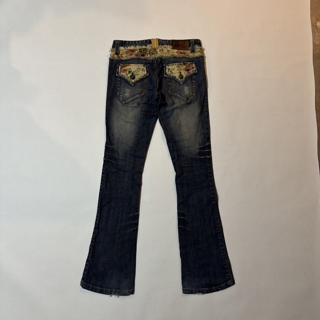 Pink Papillon Floral Patchwork Flare Denim Jeans (Category: Jeans) located in Dipolog. Submitted by dionato (Listing ID 1470675550, Image 1). Description: - Brand: Pink Papillon - Wash: Dark wash denim with a trendy flare cut - Details: Floral tapestry patchwork on the waistband and back pockets - Finish: Raw edge frayed trim for a cool, vintage look - Pockets: Button flap back pockets with decorative zig-zag stitching - Branding: Brown leather b