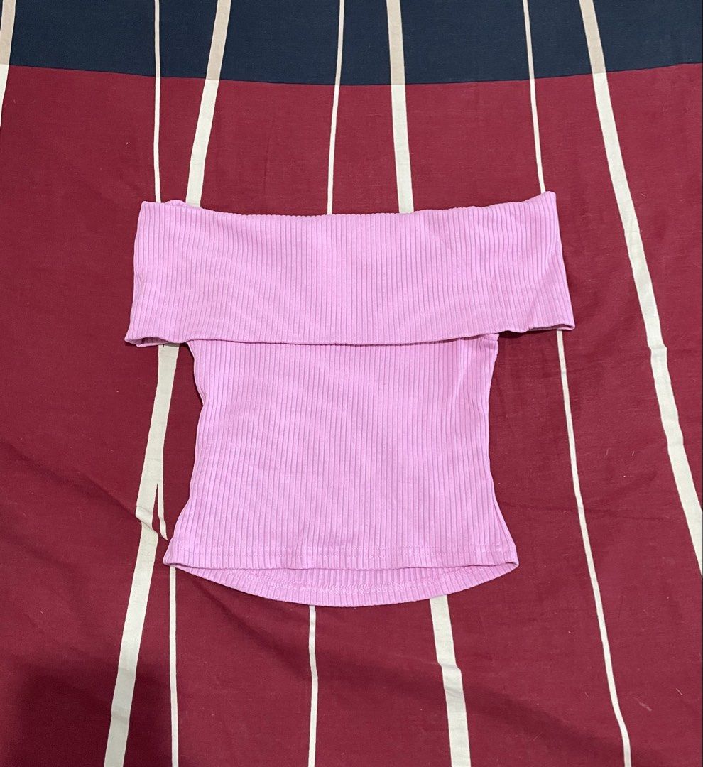 Pink Ribbed Off-Shoulder Top (Category: Sleeveless) located in Manila. Submitted by alysaysyys_ (Listing ID 1470610455, Image 1). Description: - Color: Pink - Style: Off-shoulder with foldover collar and fitted body - Material: Stretchy ribbed knit, super comfortable - Versatility: Perfect to pair with jeans or skirts - Condition: Clean and well-maintained.