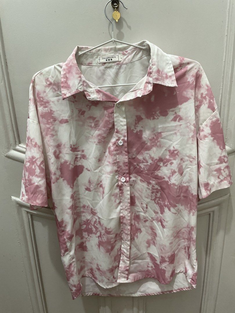 Pink Tie-Dye Short Sleeve Button-Up Shirt (Category: Tshirts & Polo Shirts ) located in Cainta. Submitted by nancygoreng (Listing ID 1470620997, Image 1). Description: - Brand: ZHUQINGCHUN - Color: Pink and white tie-dye - Style: Short sleeve button-up with collared neckline - Fit: Lightweight and loose fit - Condition/Use: Great casual piece for everyday wear.