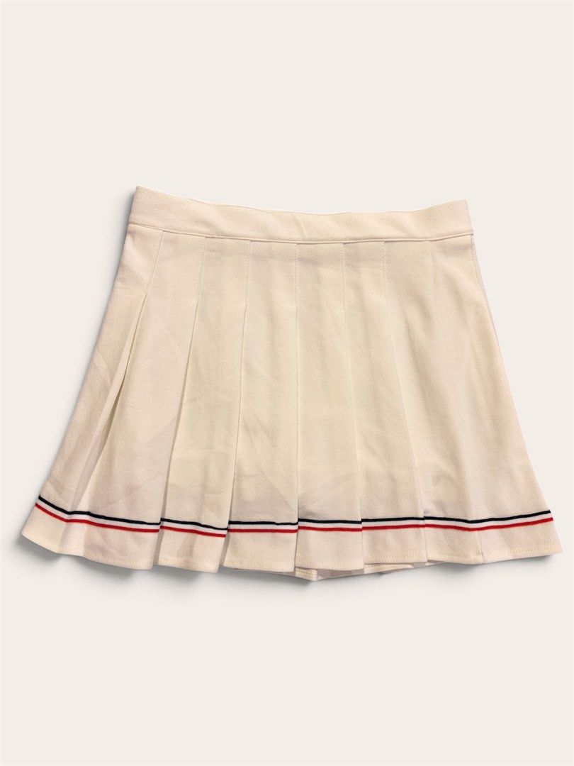 pleated tennis skirt (Category: Skirts) located in Muntinlupa City. Submitted by leileip (Listing ID 1470574069, Image 1). Description: - Style: High-waisted pleated tennis skirt - Design: Red and navy blue striped trim on the bottom hem - Material: Structured fabric that holds its shape well - Versatility: Ideal for casual wear or sporty outfits - Pairing: Looks great with simple tops and sneakers.