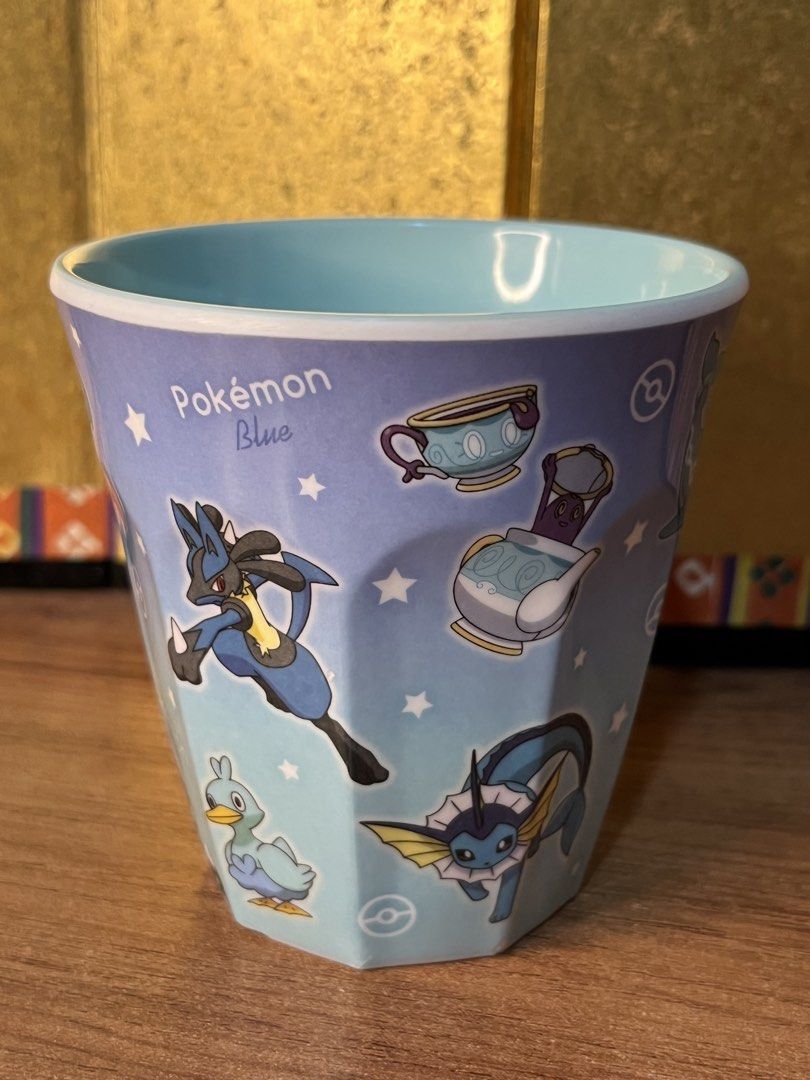 Pokémon Blue Melamine Cup Mug (Category: Coffee & Tea Tableware) located in Gapan. Submitted by lunashop14 (Listing ID 1470633837, Image 2). Description: - Official Nintendo merchandise from the Pokémon Blue collection - Features wrap-around illustrations of Lucario, Vaporeon, Quaxly, Glaceon, Lapras, Omanyte, and Polteageist - Made of durable blue melamine with a pale blue interior - Standard tumbler shape with stylish faceted sides - Official s