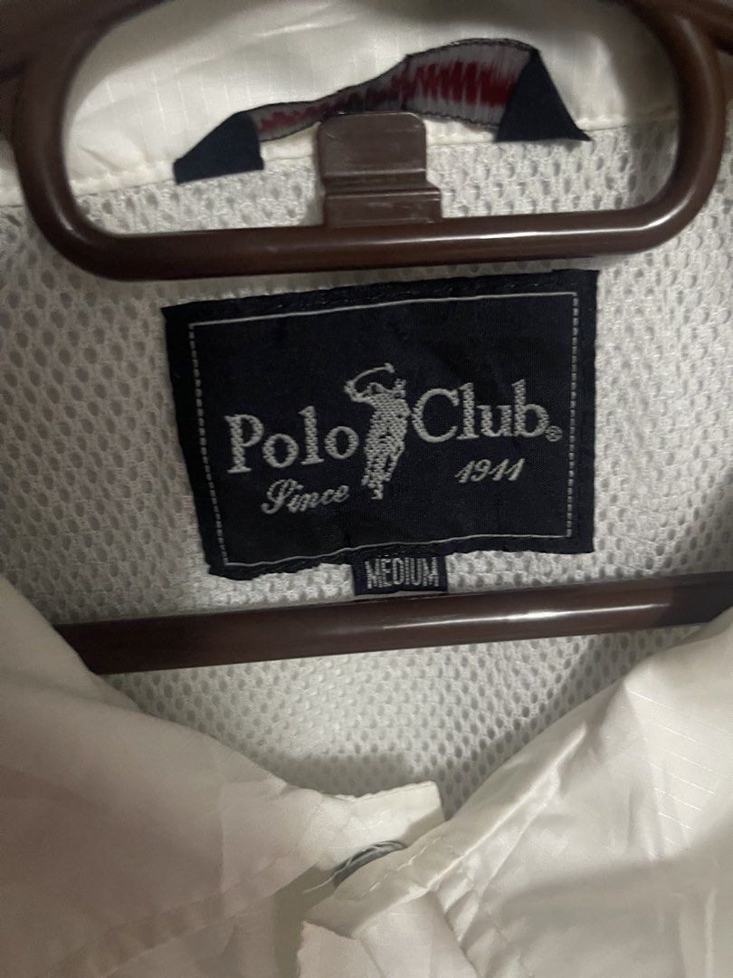 Polo Club White Windbreaker lightweight Jacket Medium (Category: Coats, Jackets and Outerwear) located in Quezon City. Submitted by listless32 (Listing ID 1470651546, Image 3). Description: Needs wash lightweight crackprint sa likod check the pic W24 L is 28 White Polo Club nylon windbreaker jacket in size Medium. Features a button-up front, side pockets, elastic cuffs, and a drawstring hem. Includes mesh lining and embroidered branding on the ch