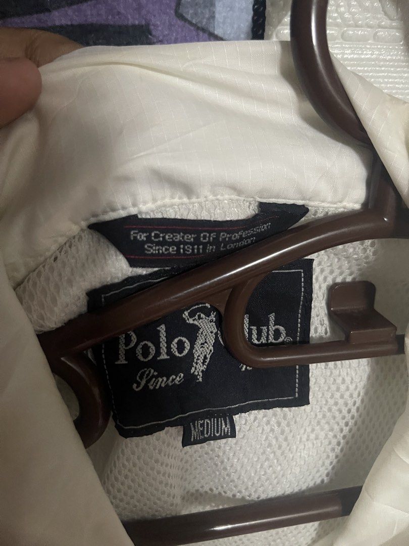 Polo Club White Windbreaker lightweight Jacket Medium (Category: Coats, Jackets and Outerwear) located in Quezon City. Submitted by listless32 (Listing ID 1470651546, Image 2). Description: Needs wash lightweight crackprint sa likod check the pic W24 L is 28 White Polo Club nylon windbreaker jacket in size Medium. Features a button-up front, side pockets, elastic cuffs, and a drawstring hem. Includes mesh lining and embroidered branding on the ch