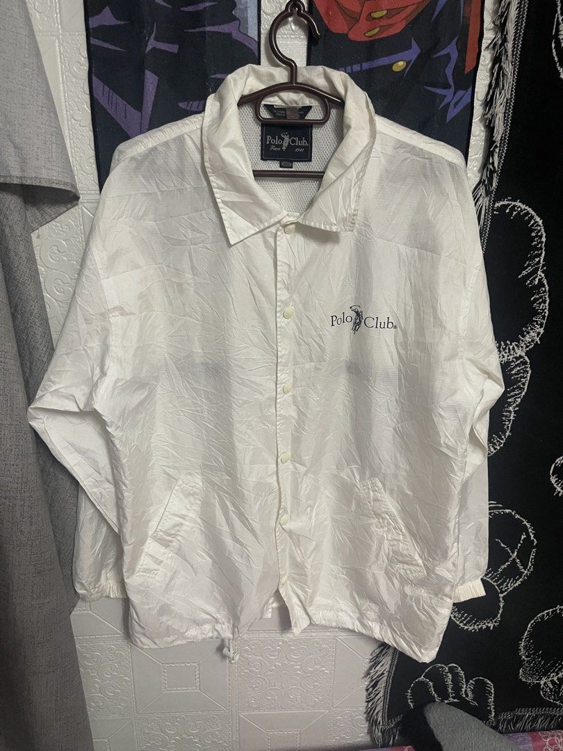 Polo Club White Windbreaker lightweight Jacket Medium (Category: Coats, Jackets and Outerwear) located in Quezon City. Submitted by listless32 (Listing ID 1470651546, Image 1). Description: Needs wash lightweight crackprint sa likod check the pic W24 L is 28 White Polo Club nylon windbreaker jacket in size Medium. Features a button-up front, side pockets, elastic cuffs, and a drawstring hem. Includes mesh lining and embroidered branding on the ch