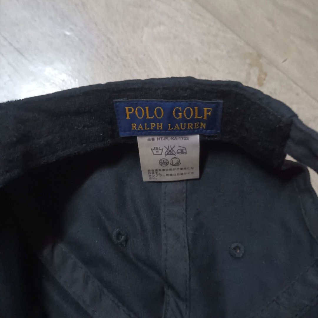 Polo Golf Ralph Lauren Cap (Category: Caps & Hats) located in Manila. Submitted by itsnik444 (Listing ID 1470641200, Image 3). Description: - Brand: Polo Golf Ralph Lauren - Color: Black - Design: Embroidered shield logo with golf clubs and plaid pattern on front - Closure: Adjustable strap back with engraved metal buckle - Details: Interior brand label and care tag intact, standard curved brim - Condition: Clean fabric, great for the course or d