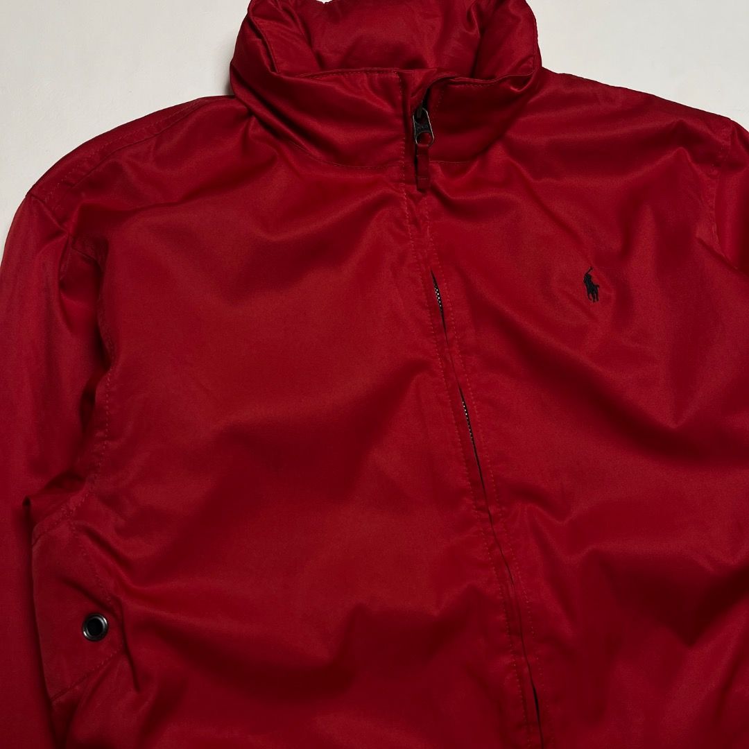 Polo Ralph Lauren Red Zip Aviator Jacket (Category: Coats, Jackets and Outerwear) located in Caloocan City. Submitted by achilles_grails (Listing ID 1470727284, Image 2). Description: - Brand: Polo Ralph Lauren - Color: Bright red with embroidered black pony logo - Size: XL - Design: Classic high collar with full front zipper and button details on pockets and collar tab - Lining: Dark fleece lining for extra warmth - Material: Durable polyester f