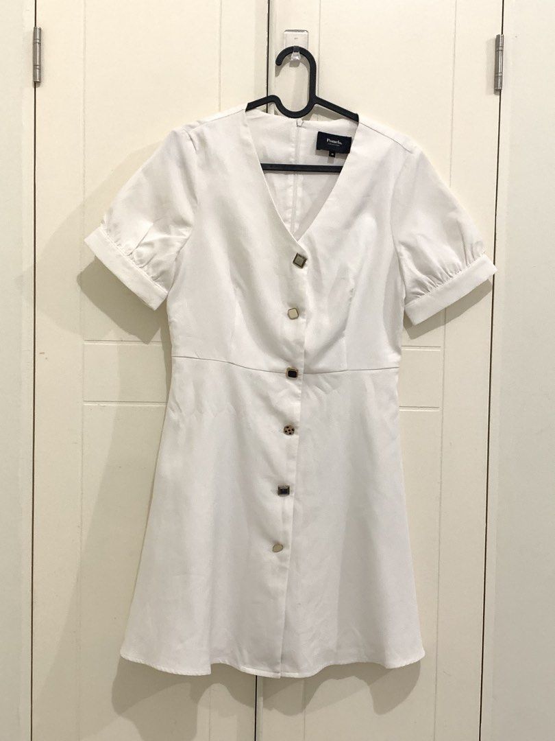 Pomelo Collection White Dress Size M (Category: Dresses) located in Pasig City. Submitted by lovedbyri (Listing ID 1470631611, Image 1). Description: - Brand: Pomelo Collection - Size: M (Tag attached) - Color: Solid White - Style: Mini dress with flared A-line skirt silhouette - Details: Short puffed sleeves with cuffed hems, V-neckline, decorative metal-trimmed front buttons - Closure: Back zip closure .