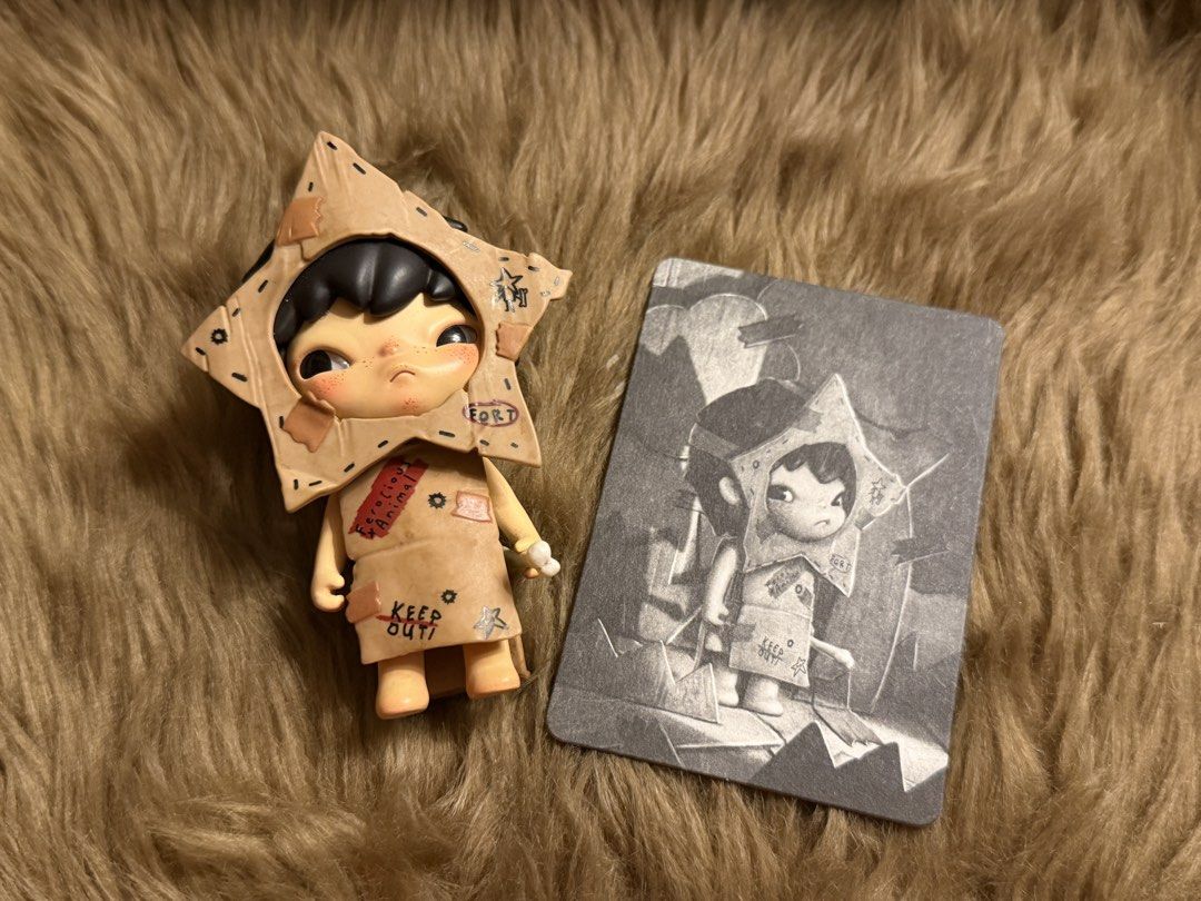 Pop Mart Hirono Shelter Warrior Figure (Category: Designer & Blind Box Toys) located in Mandaluyong City. Submitted by knb.ph (Listing ID 1470670253, Image 1). Description: - Pop Mart Hirono Shelter Series - Warrior - Figure with cardboard star costume, small bone accessory, and character card - Sturdy vinyl material with detailed paintwork including 'Stay Alert' and 'Keep Out' markings - Brand new / opened to check design only.