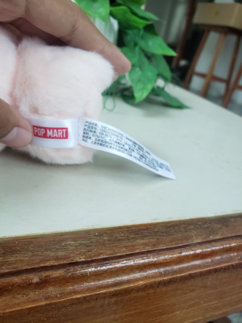 Pop Mart The Monsters Kasing Labubu Plush (Category: Plushies & Soft Toys) located in Pagsanghan. Submitted by yuchinz (Listing ID 1470661831, Image 3). Description: - Authentic Pop Mart The Monsters plush figure by Kasing - Adorable pink fur with signature plastic face, big red eyes, and pointy teeth - Includes attached key ring with branded logo ribbon - Official Pop Mart and Kasing stamp on the foot - Original care instructions and material ta