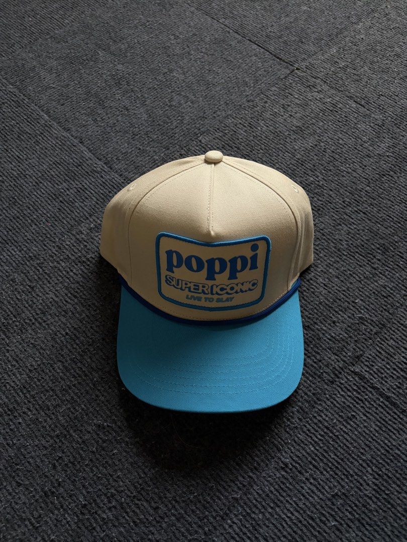 Poppi Super Iconic Snapback Cap Beige Blue (Category: Caps & Hats) located in Manila. Submitted by toys_hats005 (Listing ID 1470628678, Image 1). Description: - Brand: Poppi - Style: Snapback cap - Color: Beige body with light blue brim and matching snap closure - Front Patch: "poppi super iconic live to slay" - Interior: Clean structure with white lining band - Condition: Never worn (tag removed).