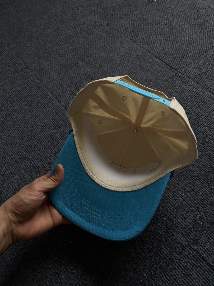 Poppi Super Iconic Snapback Cap Beige Blue (Category: Caps & Hats) located in Manila. Submitted by toys_hats005 (Listing ID 1470628678, Image 3). Description: - Brand: Poppi - Style: Snapback cap - Color: Beige body with light blue brim and matching snap closure - Front Patch: "poppi super iconic live to slay" - Interior: Clean structure with white lining band - Condition: Never worn (tag removed).