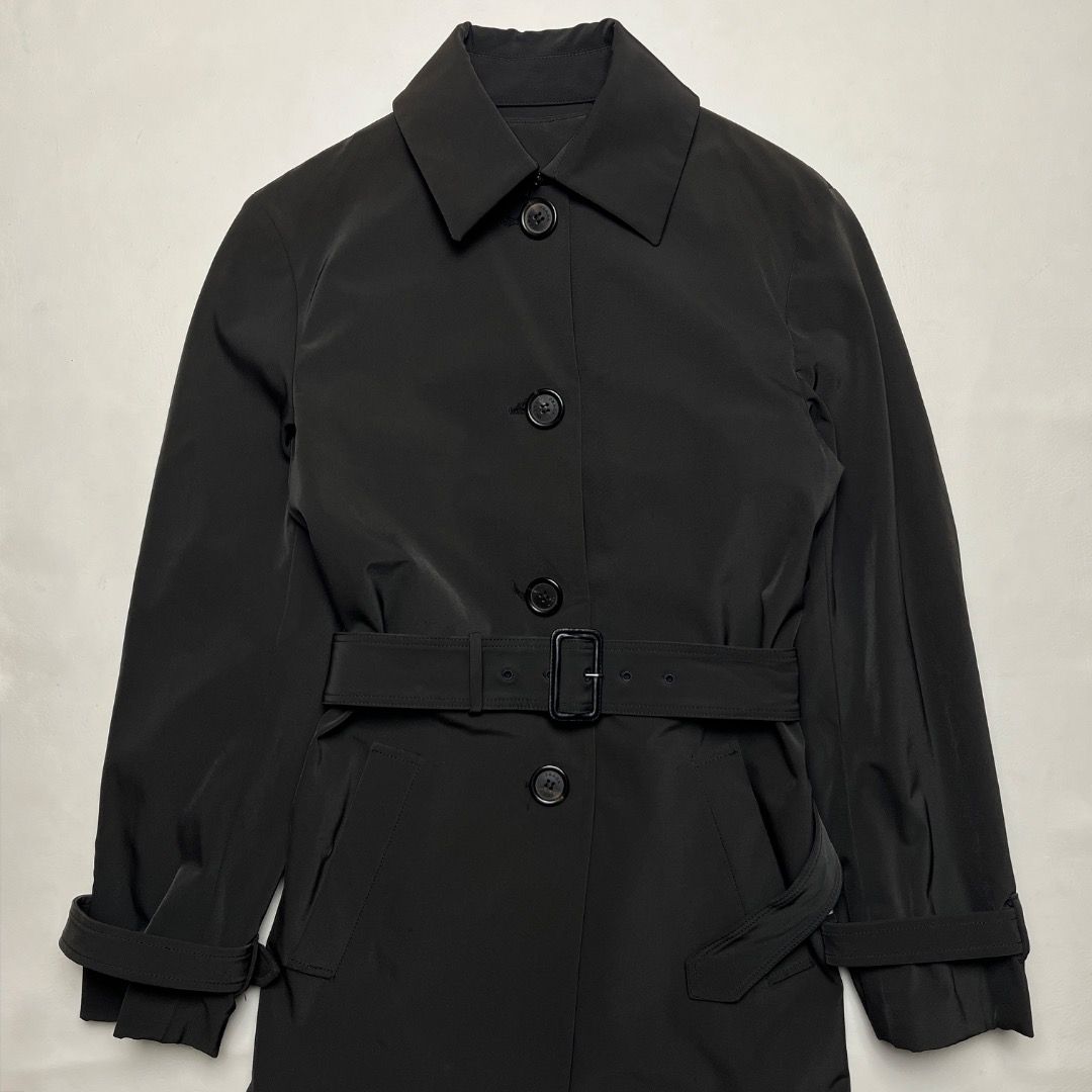 Prada Archive Trench Coat (Category: Coats, Jackets and Outerwear) located in Caloocan City. Submitted by achilles_grails (Listing ID 1470565272, Image 2). Description: - 100% Authentic Prada black trench coat - Size: 38 (marked on inner tag) - Classic button-front closure with matching waist belt - Adjustable sleeve straps and structured collar - Smooth dark inner lining - Timeless Italian luxury design, ideal for transitional weather or formal 