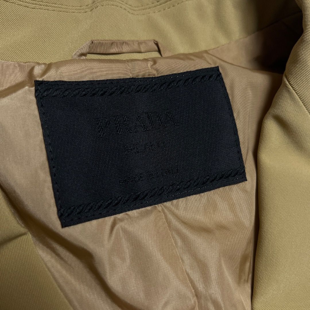 Prada Beige Buttoned Blazer Jacket (Category: Coats, Jackets and Outerwear) located in Caloocan City. Submitted by achilles_grails (Listing ID 1470604173, Image 2). Description: - Color: Elegant beige - Size: XS on tag Fits small - Material: 90% polyester, 10% elastane with smooth inner lining - Closure & Pockets: 3 black front buttons and functional side flap pockets - Details: Structured lapels for a sharp silhouette - Care: Dry clean only - Co