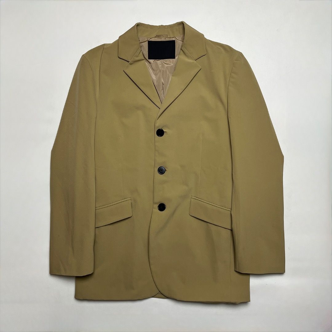 Prada Beige Buttoned Blazer Jacket (Category: Coats, Jackets and Outerwear) located in Caloocan City. Submitted by achilles_grails (Listing ID 1470604173, Image 1). Description: - Color: Elegant beige - Size: XS on tag Fits small - Material: 90% polyester, 10% elastane with smooth inner lining - Closure & Pockets: 3 black front buttons and functional side flap pockets - Details: Structured lapels for a sharp silhouette - Care: Dry clean only - Co