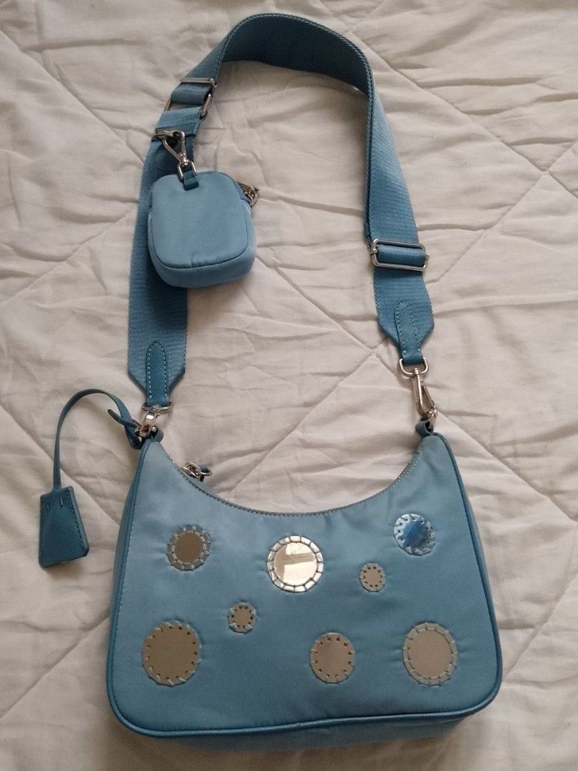 Prada Blue Mirror Re-Edition Bag (Category: Luxury Bags & Wallets) located in Manila. Submitted by anvicnicajeff (Listing ID 1470669817, Image 3). Description: - Authentic Prada blue nylon shoulder bag -100% AUTHENTIC you can grab my photo and legit check it to the group -Meetup only in shangrila shaw so that you can see it clearly - Eye-catching round mirror patches on the front -Lost chain but still has the sling strap - Includes a matching adj