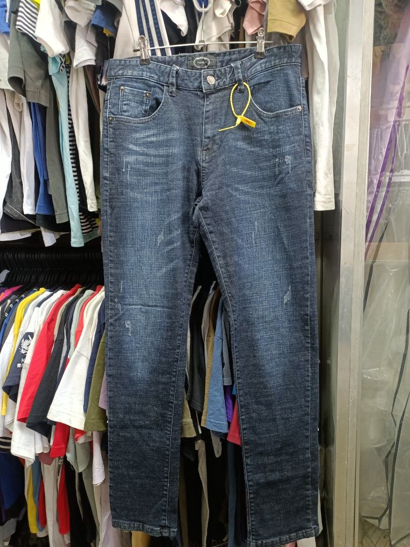 Prada Dark Blue Denim Jeans Size 31 (Category: Jeans) located in Bayombong. Submitted by rheaaa00530 (Listing ID 1470670317, Image 1). Description: - Brand: Prada - Color: Dark blue with distressed wash - Size: Tagged 31 - Material: 99% cotton, 1% spandex for a comfortable fit - Fit: Standard straight fit - Details: Branded button closure, custom pocket rivets, and signature Prada triangle logo badge on the back pocket - Condition: Clean inside a