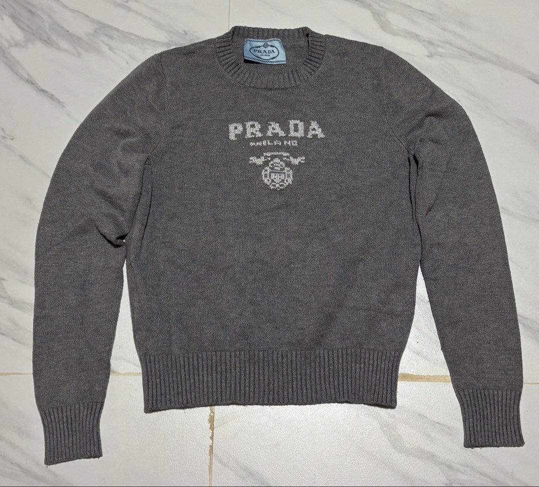 Prada Milano Grey Knit Sweater (Category: Coats, Jackets and Outerwear) located in Baguio. Submitted by thriftedbaguio (Listing ID 1470597231, Image 1). Description: Excellent Condition Size Xlarge Tagged Dimensions 18*25 Color rate 10.