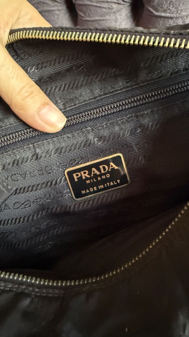 Prada Quilted Nylon Chain Shoulder Bag Black B2811 (Category: Luxury Bags & Wallets) located in Manila. Submitted by ac32370 (Listing ID 1470603802, Image 2). Description: - Brand: Prada - Model: B2811 (Nero) - Material: Black quilted nylon - Hardware: Gold-tone chain strap interwoven with leather - Details: Iconic triangle logo plaque on front flap, fabric-lined interior with zip pocket - Inclusions: Authentication cards and envelopes as picture