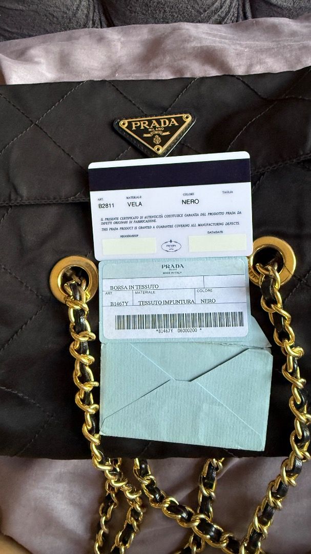 Prada Quilted Nylon Chain Shoulder Bag Black B2811 (Category: Luxury Bags & Wallets) located in Manila. Submitted by ac32370 (Listing ID 1470603802, Image 1). Description: - Brand: Prada - Model: B2811 (Nero) - Material: Black quilted nylon - Hardware: Gold-tone chain strap interwoven with leather - Details: Iconic triangle logo plaque on front flap, fabric-lined interior with zip pocket - Inclusions: Authentication cards and envelopes as picture