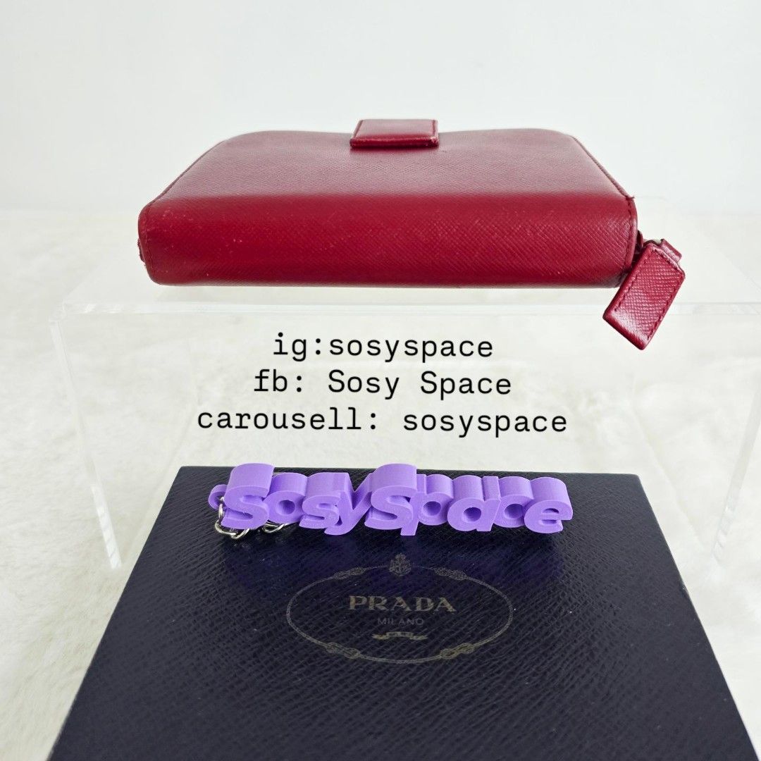 Prada Saffiano Wallet (Category: Luxury Bags & Wallets) located in Lucena. Submitted by sosyspace (Listing ID 1470586414, Image 3). Description: P. R. A. D. A. 40B1P127 Saffiano leather in shade of red Bi-fold compartment with snap-button closure on one side, paired with a zippered accordion coin pouch on the other 14 x 3 x 11 cm Condition: PRELOVED minor signs of use still excellent for me. Includes: box Price: PHP 15,000 + HF + SF 💜💜💜💜💜💜 