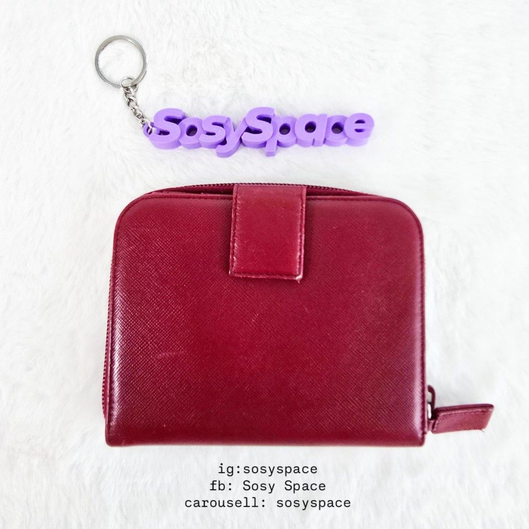 Prada Saffiano Wallet (Category: Luxury Bags & Wallets) located in Lucena. Submitted by sosyspace (Listing ID 1470586414, Image 2). Description: P. R. A. D. A. 40B1P127 Saffiano leather in shade of red Bi-fold compartment with snap-button closure on one side, paired with a zippered accordion coin pouch on the other 14 x 3 x 11 cm Condition: PRELOVED minor signs of use still excellent for me. Includes: box Price: PHP 15,000 + HF + SF 💜💜💜💜💜💜 