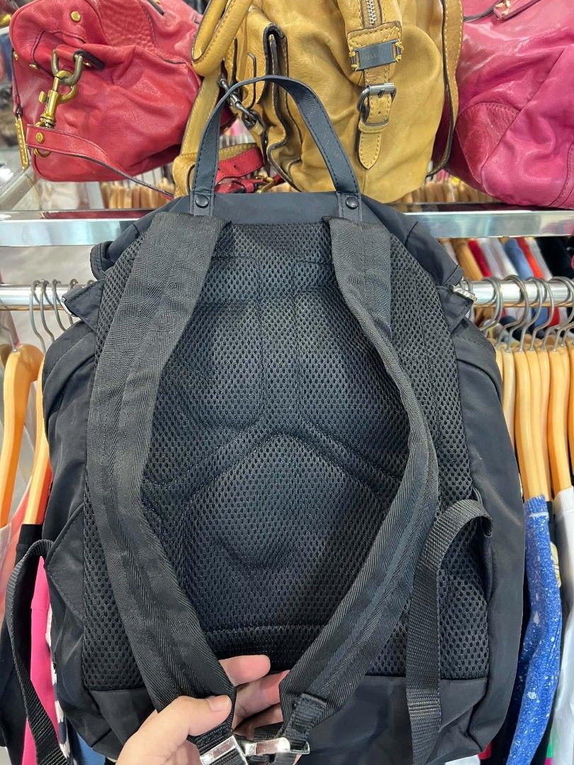 Prada x Adidas Re-Nylon Black Backpack (Category: Backpacks) located in Urdaneta. Submitted by jayceegarage (Listing ID 1470692265, Image 2). Description: - Authentic Prada x Adidas collaboration backpack in classic black - Crafted from sustainable and durable Re-Nylon material - Iconic triangular metal Prada logo plaque on the front - Secure drawstring closure with adjustable buckle straps - Breathable mesh padded back panel for extra comfort - 