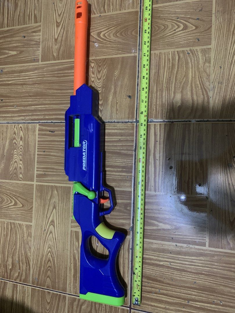 Predator Toy Blaster Blue Orange Green (Category: Action & Battle Toys) located in Antipolo. Submitted by cebb888 (Listing ID 1470639606, Image 1). Description: - Product: Predator toy blaster - Size: Measures approximately 25 inches long - Colorway: Blue main body with bright orange barrel extension and green accents, bolt handle, and grip panels - Features: Orange trigger inside safety guard - Perfect for: Backyard games and target practice - w