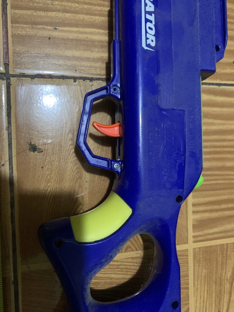 Predator Toy Blaster Blue Orange Green (Category: Action & Battle Toys) located in Antipolo. Submitted by cebb888 (Listing ID 1470639606, Image 3). Description: - Product: Predator toy blaster - Size: Measures approximately 25 inches long - Colorway: Blue main body with bright orange barrel extension and green accents, bolt handle, and grip panels - Features: Orange trigger inside safety guard - Perfect for: Backyard games and target practice - w