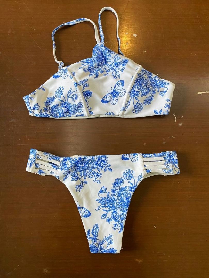 *Preloved Bikini Bottom Tinted White M (Category: Bikinis & Swimsuits) located in Muntinlupa City. Submitted by irene.aragon.navarro (Listing ID 1470621593, Image 1). Description: Tinted white two-piece bikini. High neck top with racerback straps. Bottoms have multi-strap sides. Pretty floral and butterfly print all over..