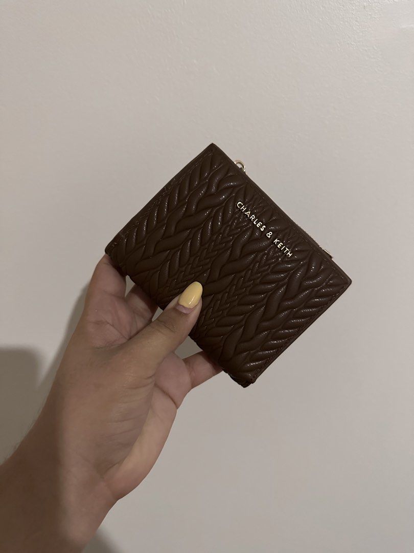 Preloved Charles & Keith Brown Wallet (Category: Wallets & Card holders) located in Bacoor. Submitted by alliabuysandsells (Listing ID 1470708611, Image 1). Description: charles & keith preloved wallet (not sure if it’s authentic bought it here on carousell) brown braided pattern no issues comes with box.