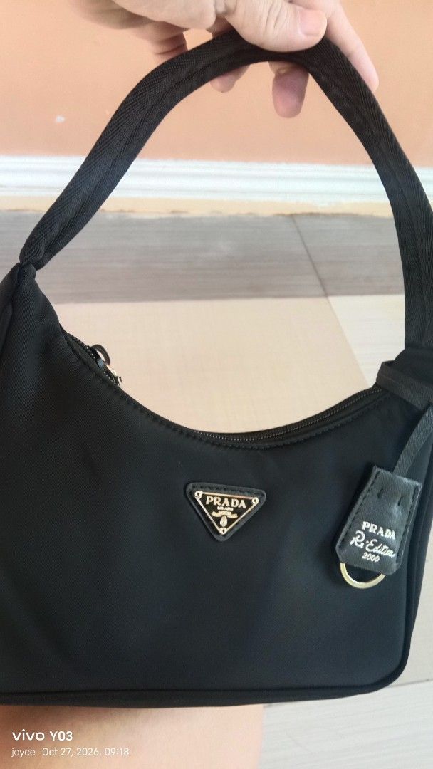 Preloved Prada Re-Edition 2000 Nylon Mini Bag Black (Category: Luxury Bags & Wallets) located in Cabuyao City. Submitted by selections888 (Listing ID 1470590772, Image 2). Description: - preloved Prada Re-Edition 2000 smallbag in classic black nylon - preloved from Japan supplier - Features iconic metal triangle logo plaque and gold-tone hardware - Secure zip closure with a sturdy black fabric handle strap - Timeless Y2K aesthetic, clean silhouet