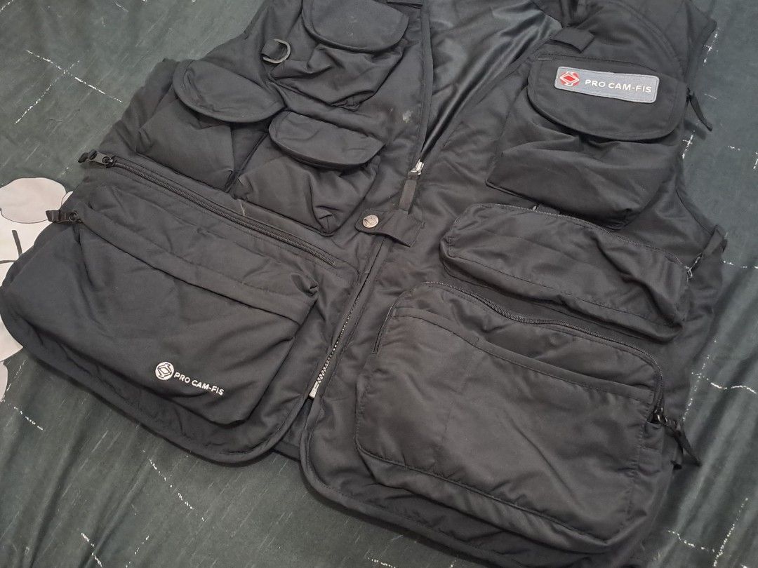 Pro Cam-Fis Black Utility Vest with Multiple Pockets (Category: Vests) located in Puerto Princesa. Submitted by jercksthriftph (Listing ID 1470654986, Image 3). Description: - Brand/Model: Pro Cam-Fis Utility Vest - Color: Black - Pockets: Loaded with functional pockets on chest and lower front panels for gear and accessories - Closure: Durable center zip with branded patches - Design: Practical sleeveless style, great for layering - Ideal For: O