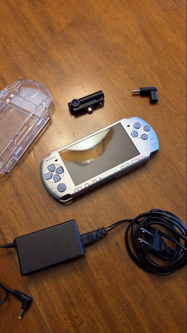 PSP 3000 (modded) (Category: PlayStation) located in Quezon City. Submitted by juannnndlcr (Listing ID 1470612807, Image 1). Description: Selling my Sony PSP 3000 Silver in good working condition. Fully functional and modded, with some minor scratches and signs of use. Inclusions: • Sony PSP 3000 Silver (Modded) • Original PSP Camera (Working, PSP-450) • PSP Charger and Power Adapter • Clear Protective Case • Charging Adapter Condition: • 7.5/10 