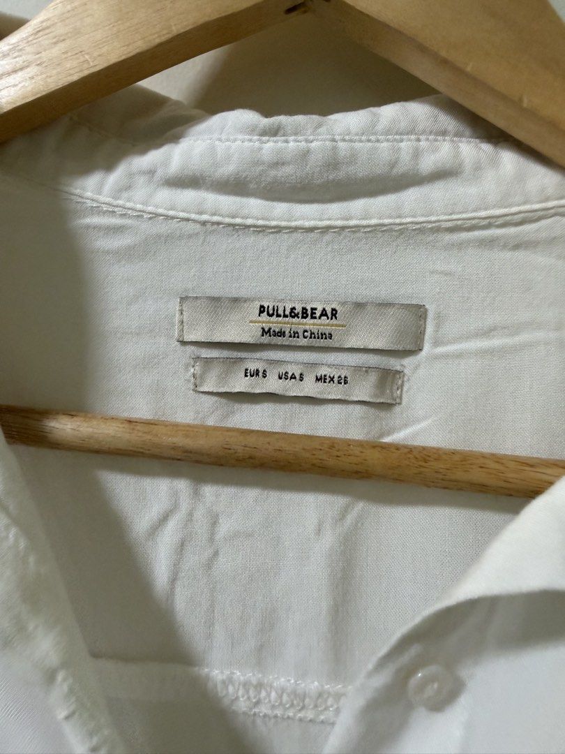 Pull&Bear White Short Sleeve Button-Up Shirt Size S (Category: Shirts) located in Makati City. Submitted by andzr. (Listing ID 1470644193, Image 2). Description: - Brand: Pull&Bear - Style: Short-sleeve button-up shirt with rolled cuffs, classic collar, and single chest pocket - Size: S (EUR/USA/MEX) - Material: Lightweight - Condition: Clean and ready to wear.