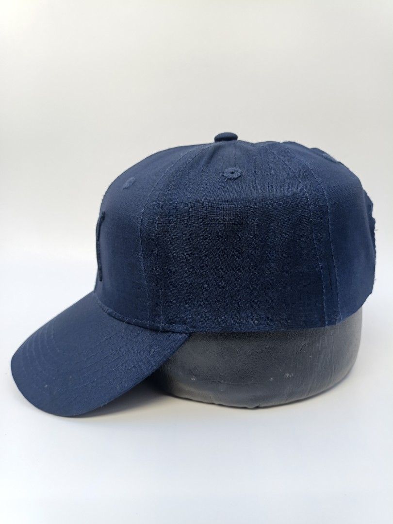 Puma Navy Blue Embroidered Logo Baseball Cap OSFA (Category: Caps & Hats) located in Imus. Submitted by grindhouse.thriftshop (Listing ID 1470606889, Image 3). Description: - Brand: Puma - Color: Navy blue - Design: Embroidered leaping cat logo on the front - Fit: One size fits all with an adjustable back strap - Material: 100% polyester body, 100% cotton sunshade back - Details: Branded interior taping along the seams - Condition: Clean inside a