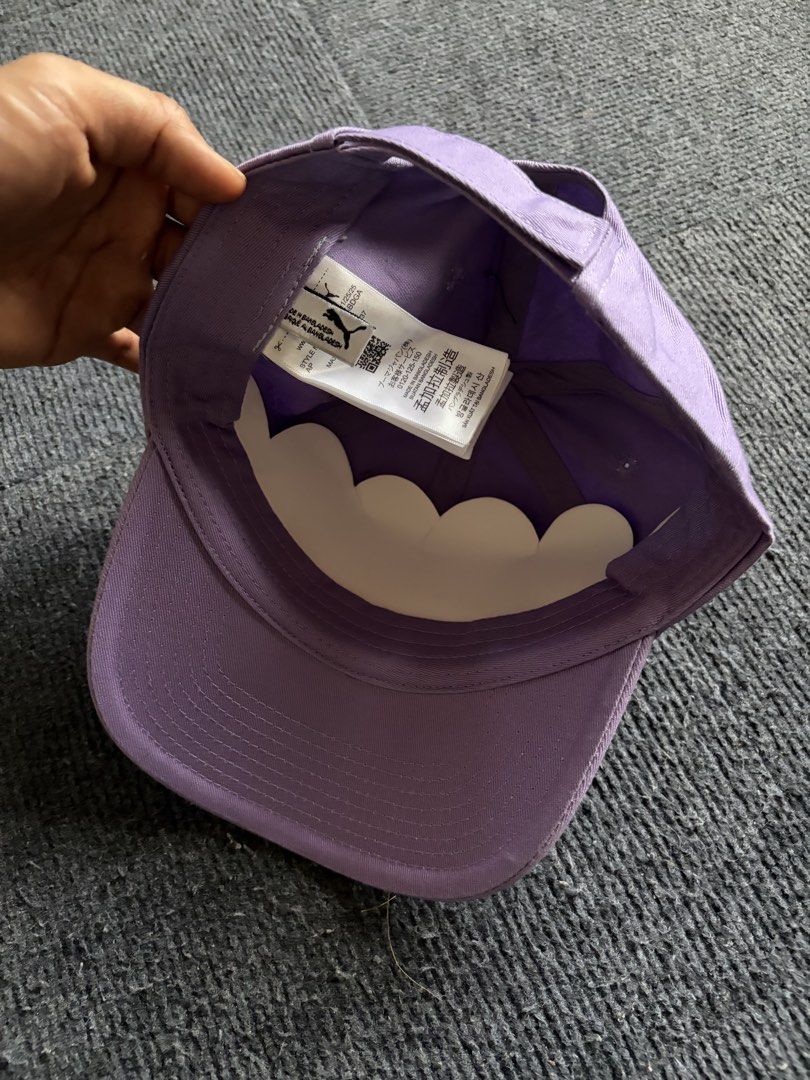 Puma Purple Cap (Category: Caps & Hats) located in Manila. Submitted by toys_hats005 (Listing ID 1470628609, Image 3). Description: - Brand: Puma - Color: Purple with pink embroidered logo - Condition: Brand new, unworn with original cardboard shape insert - Features: Curved brim with holographic sticker, adjustable back strap - Origin: Made in Bangladesh.
