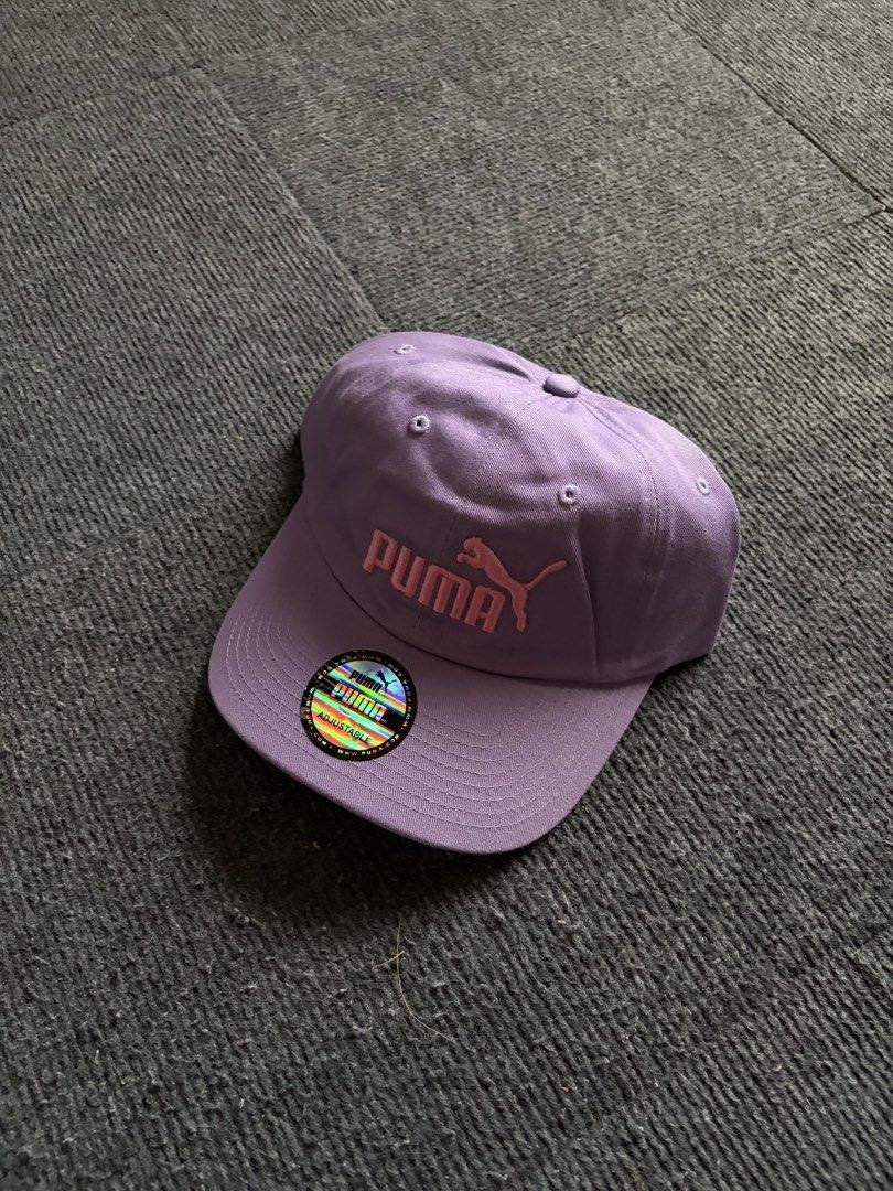 Puma Purple Cap (Category: Caps & Hats) located in Manila. Submitted by toys_hats005 (Listing ID 1470628609, Image 1). Description: - Brand: Puma - Color: Purple with pink embroidered logo - Condition: Brand new, unworn with original cardboard shape insert - Features: Curved brim with holographic sticker, adjustable back strap - Origin: Made in Bangladesh.