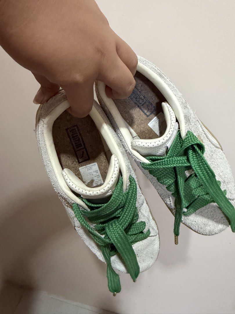 Puma Suede White and Green Sneakers (Category: Sneakers) located in Cebu City. Submitted by maeannxoxo (Listing ID 1470669856, Image 2). Description: - Brand: Puma Suede - Color: Off-white with thick green laces and gold aglets - Details: Gold Puma branding on the side and heel, classic gum sole, and cork insoles - Condition: Worn a few times, uppers and soles still holding up very well - Fit: Great casual pair for everyday rotation.