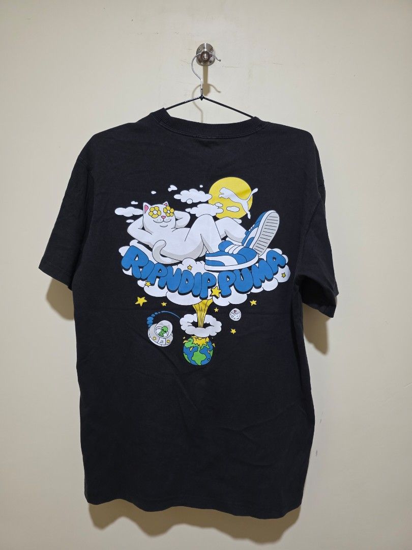 Puma x RIPNDIP Graphic T-Shirt (Category: Tshirts & Polo Shirts ) located in Cebu City. Submitted by epicocean_d0dd19 (Listing ID 1470592232, Image 3). Description: - Brand: Puma x Ripndip Collaboration - Color: Black - Size: Small (S tag at the collar) - Details: Puma logo tag near the hem, ribbed crewneck neckline - Condition: Pre-loved - Mode of Payment: GCash or Bank Transfer - Shipping: Via J&T Express (Buyer shoulders shipping fee).