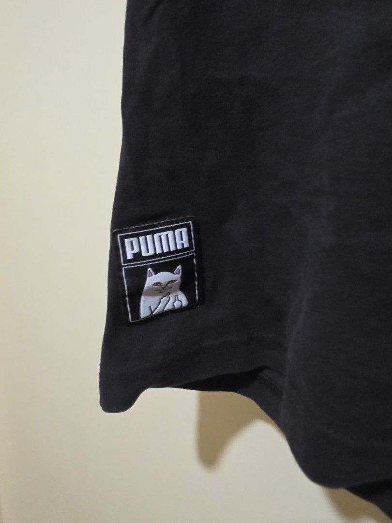 Puma x RIPNDIP Graphic T-Shirt (Category: Tshirts & Polo Shirts ) located in Cebu City. Submitted by epicocean_d0dd19 (Listing ID 1470592232, Image 2). Description: - Brand: Puma x Ripndip Collaboration - Color: Black - Size: Small (S tag at the collar) - Details: Puma logo tag near the hem, ribbed crewneck neckline - Condition: Pre-loved - Mode of Payment: GCash or Bank Transfer - Shipping: Via J&T Express (Buyer shoulders shipping fee).