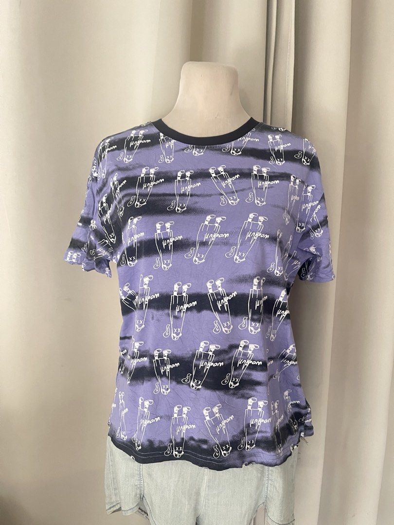 Purple Graphic Print Ringertee (Category: Shirts) located in Cainta. Submitted by zlove111 (Listing ID 1470738506, Image 1). Description: - Style: Streetwear casual short sleeve t-shirt - Design: Purple base with black horizontal stripes and all-over white cartoon character print - Details: Black contrast ringer crewneck collar - Material: Soft, comfortable cotton - Fit: Standard casual fit small/semi large - Versatility: Easy to style with denim